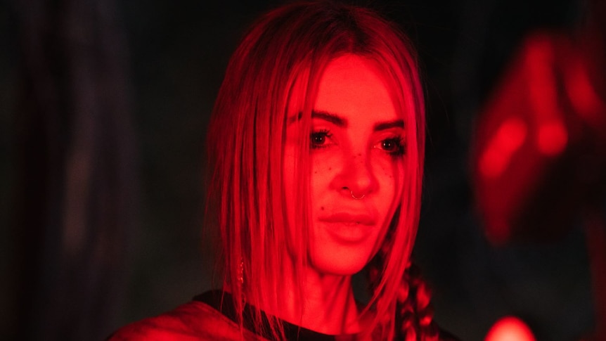 Press image of Alison Wonderland; subject photographer under red lights