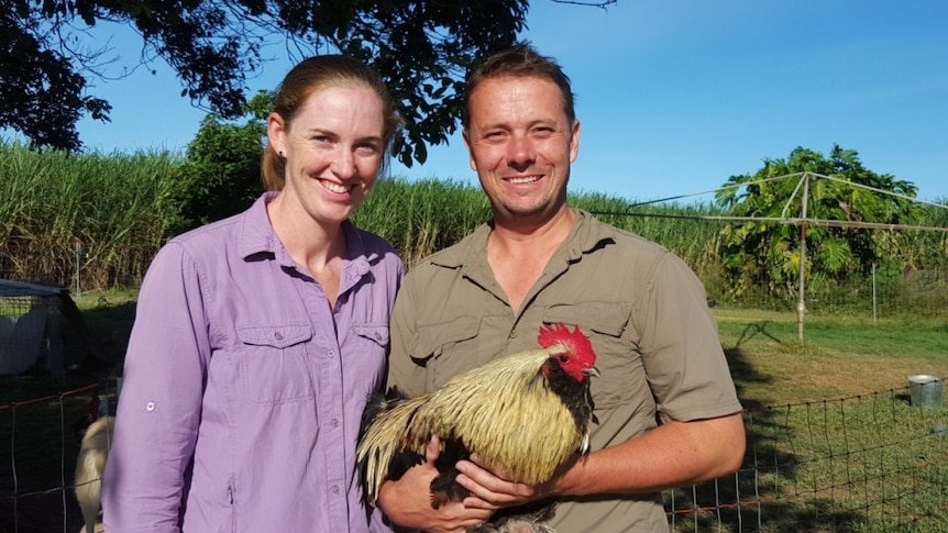 Dan and Leanne Cordner hold one of their free range chickens at their sugar cane farm near Ingham