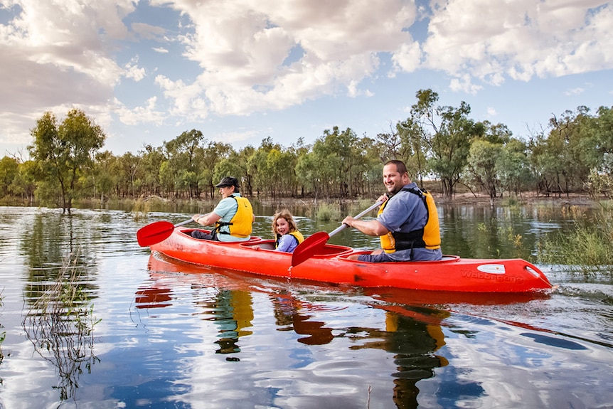 Three people in a canoe paddleing