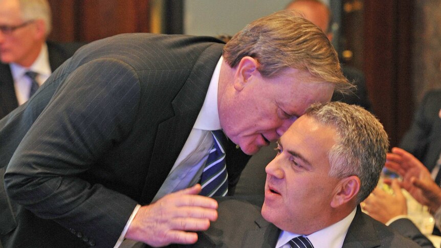 Peter Costello (L) speaks with federal Treasurer Joe Hockey at an ANZ luncheon in Melbourne on September 5, 2014