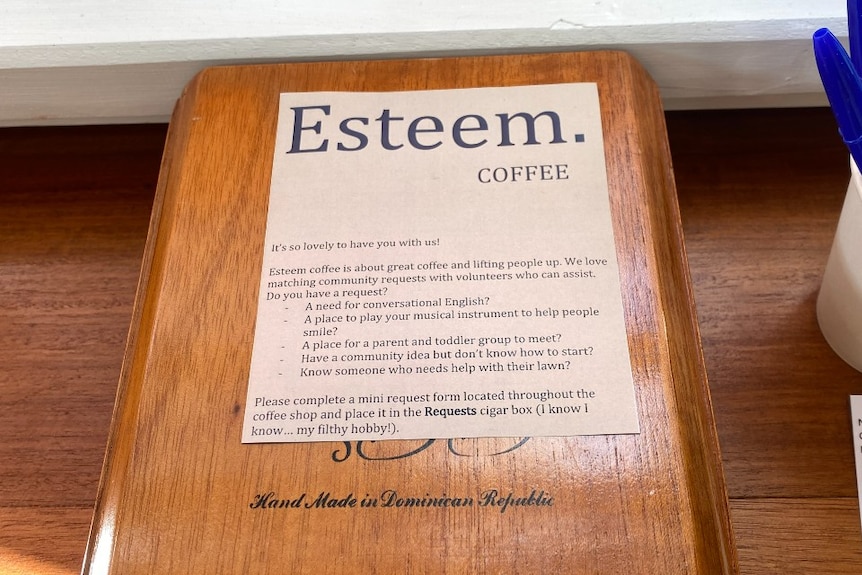 A wooden box with a sign on the top reading Esteem Coffee