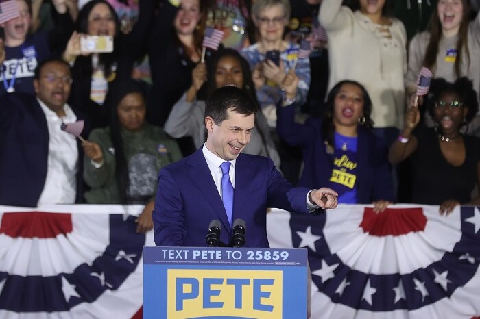 Pete Buttigieg in front of a crowd at a podium