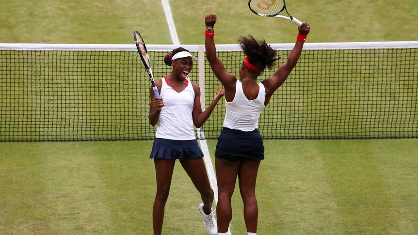 Serena Williams (R) and Venus Williams (L) celebrate gold medal
