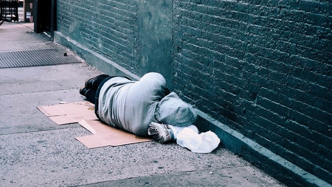 Homeless man sleeping on the ground