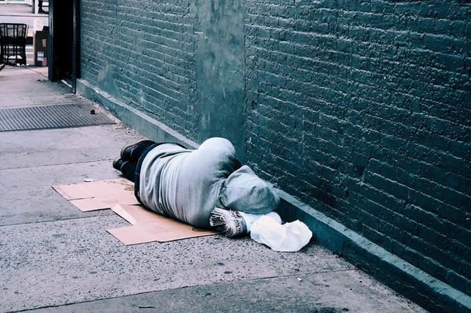 Homeless man sleeping on the ground