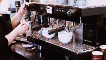 A barista making coffee.