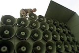 A South Korean soldier works to remove loudspeakers