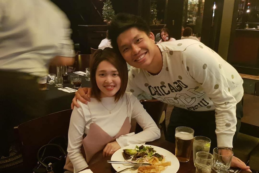 Chee Kit Chong and wife Angie Yeh Ling Liaw smile at a restaurant