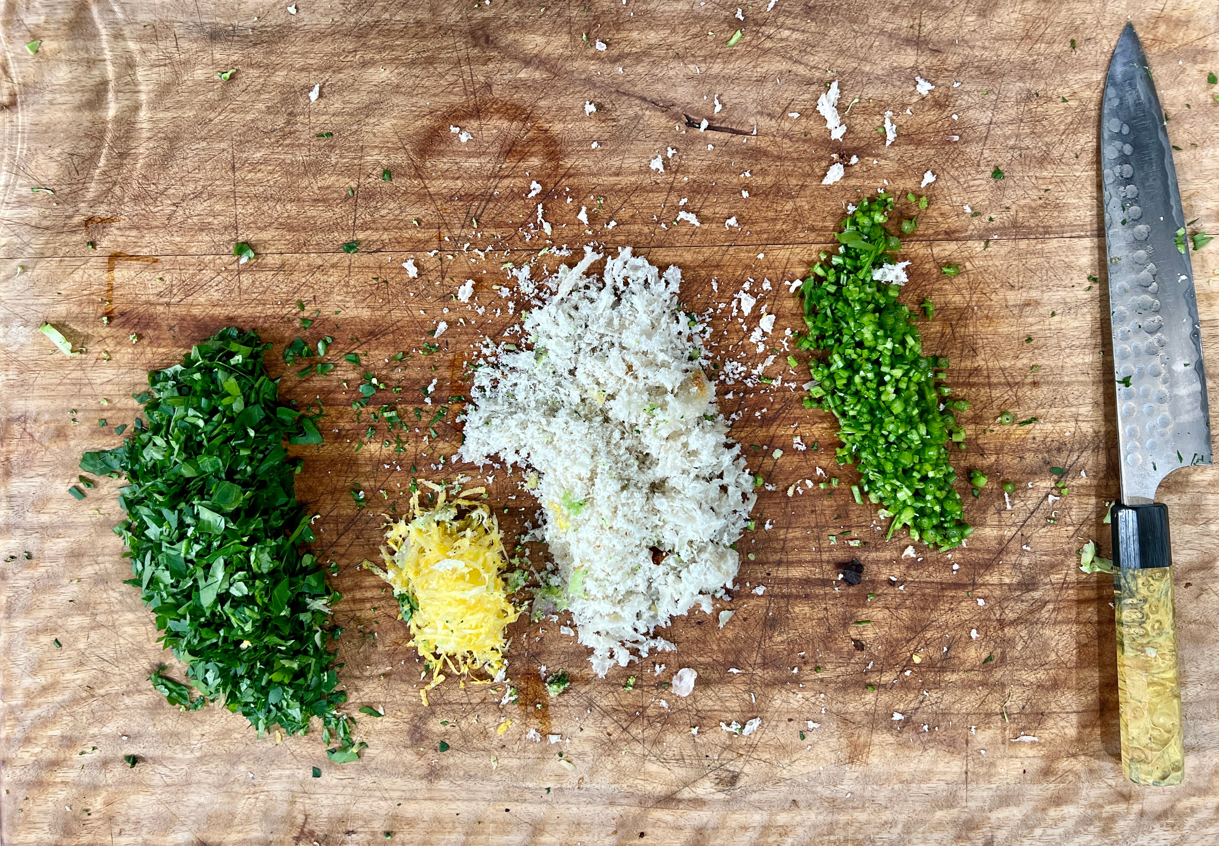 chopped and dices ingredients on top of chopping board for box grater broccoli pasta