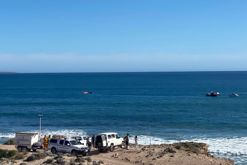 Emergency service and other vehicles at a beach.