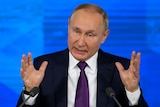 The Russian President gestures with his hands