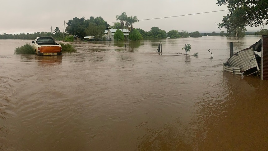 Water surrounds a farm house