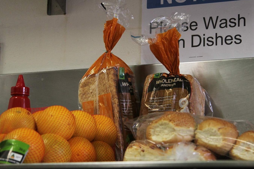 A photo of some bags of bread and other food items on a kitchen counter.