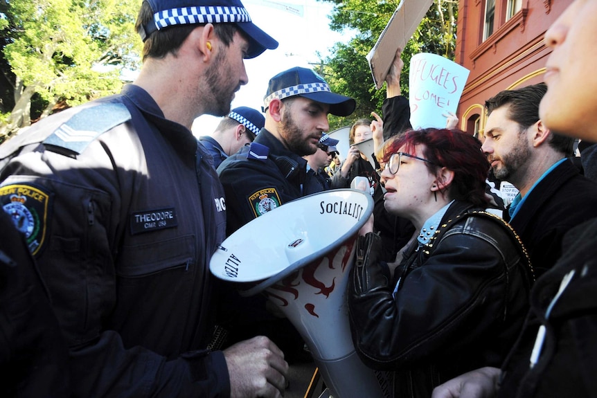 NSW Police push back protesters outside a Federal Labor Caucus meeting at Balmain Town Hall.