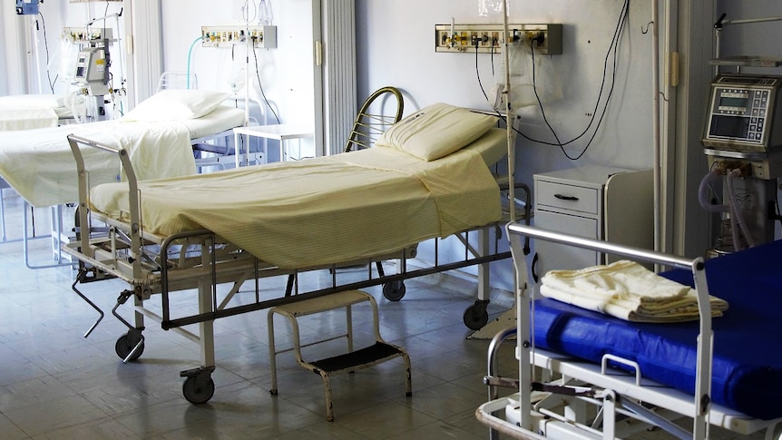 Empty beds in a hospital ward.