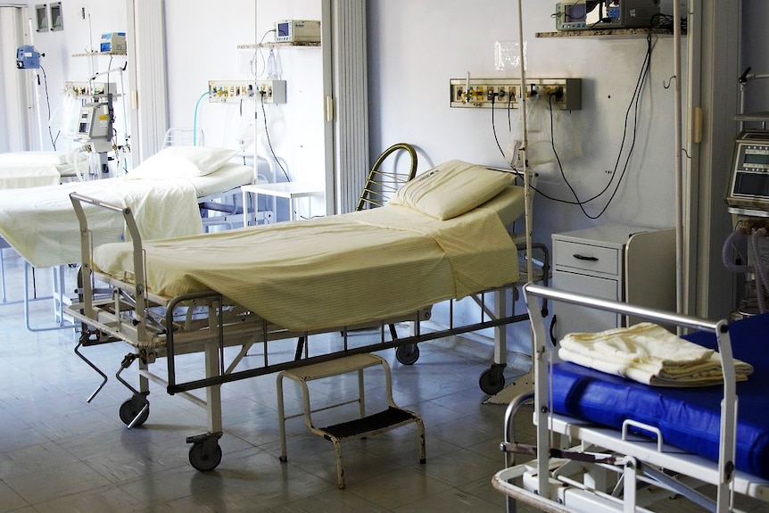 Empty beds in a hospital ward.