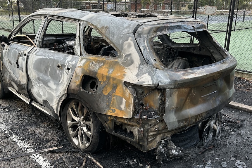 A car that was stolen sits burned out