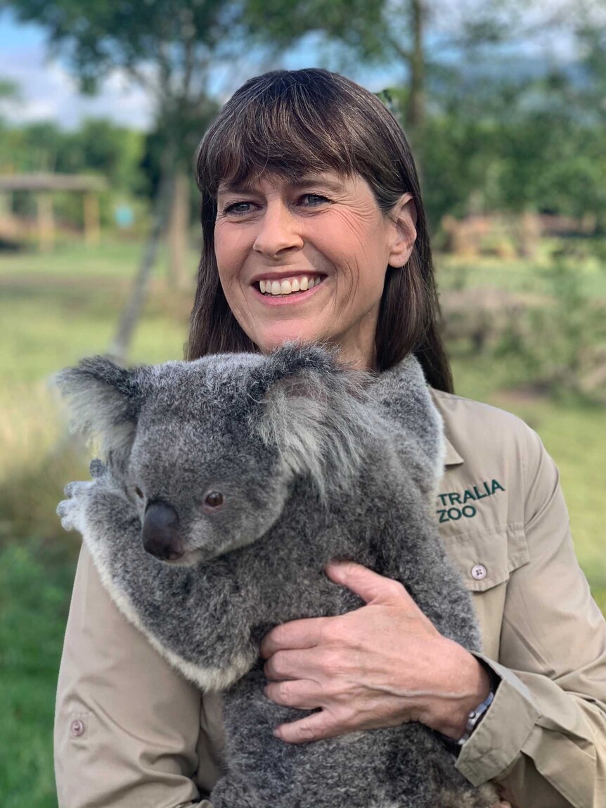 Woman holding a koala