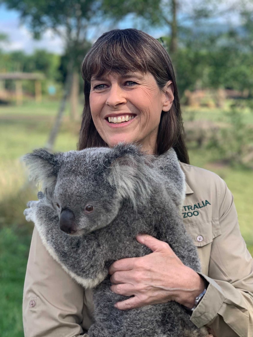 Woman holding a koala.