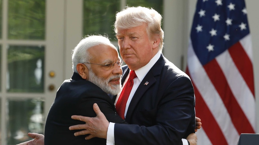 Indian PM Narendra Modi goes in for a cuddle with Mr Trump (Photo: Reuters)