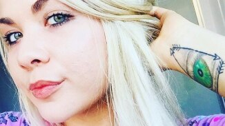 blonde woman with a tattoo on her wrist