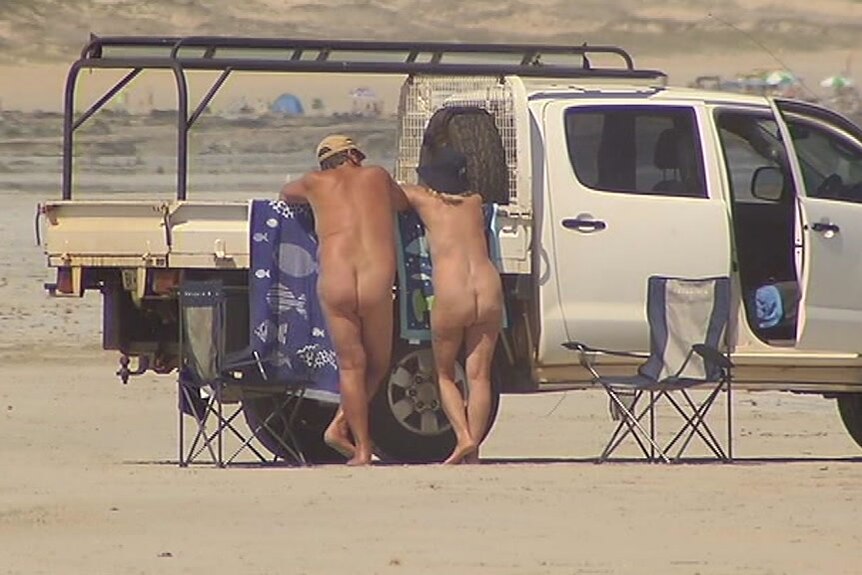 Nudists on Cable Beach leaning on the back of a ute talking