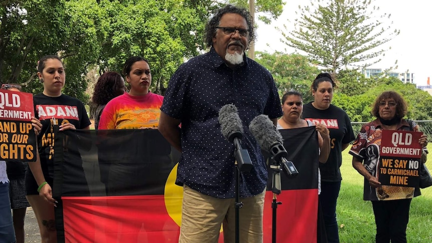 Adrian Burragubba from the W&J traditional owners holding a media conference, flanked by other W&J members