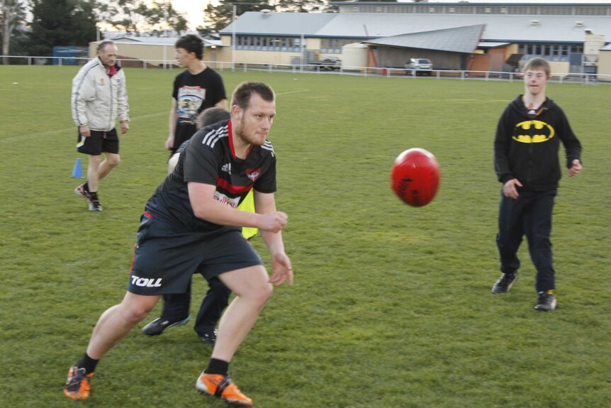 Alan 'Dingo' Dengate gives off a handball during traing in Launceston