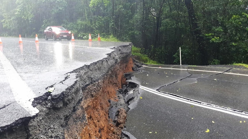 a severely damaged road cut completely in half