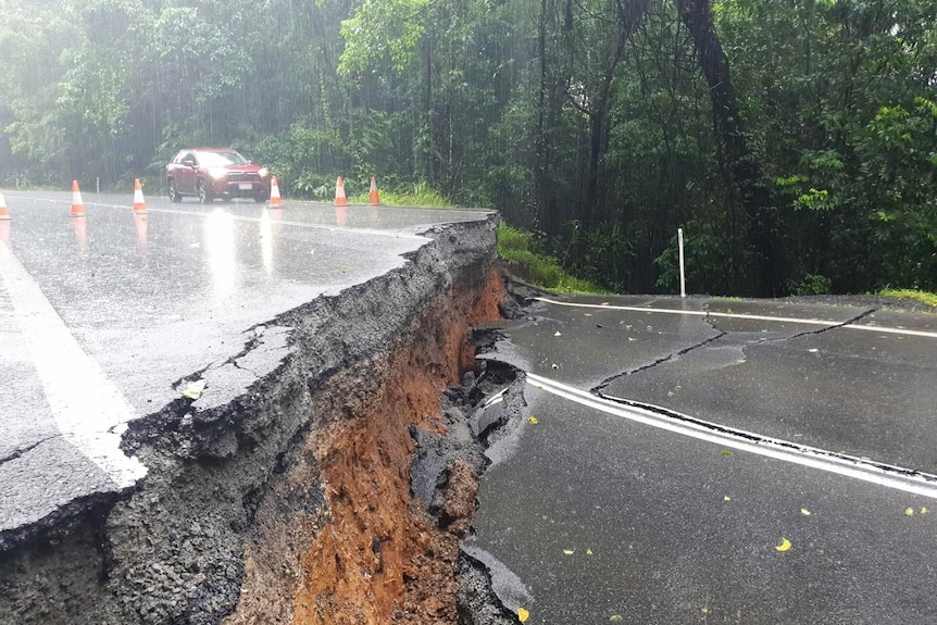 a severely damaged road cut completely in half