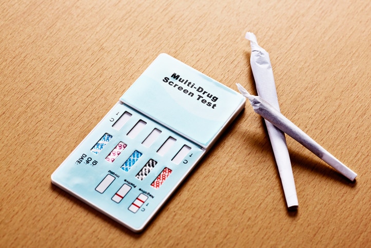 A random drug test kit is laid out on a table