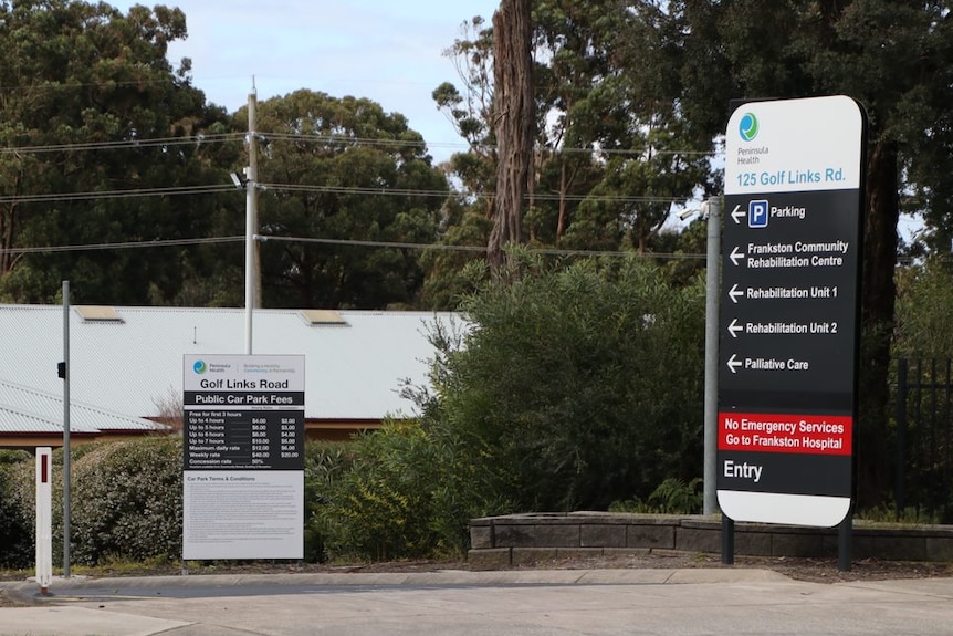 A single storey building with signage out the front.