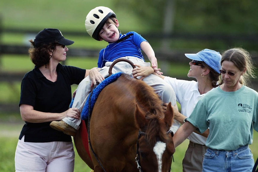 Eight year-old Michael Dedrick-Dwyer, who has Cerebral Palsy and Autism, rides a horse