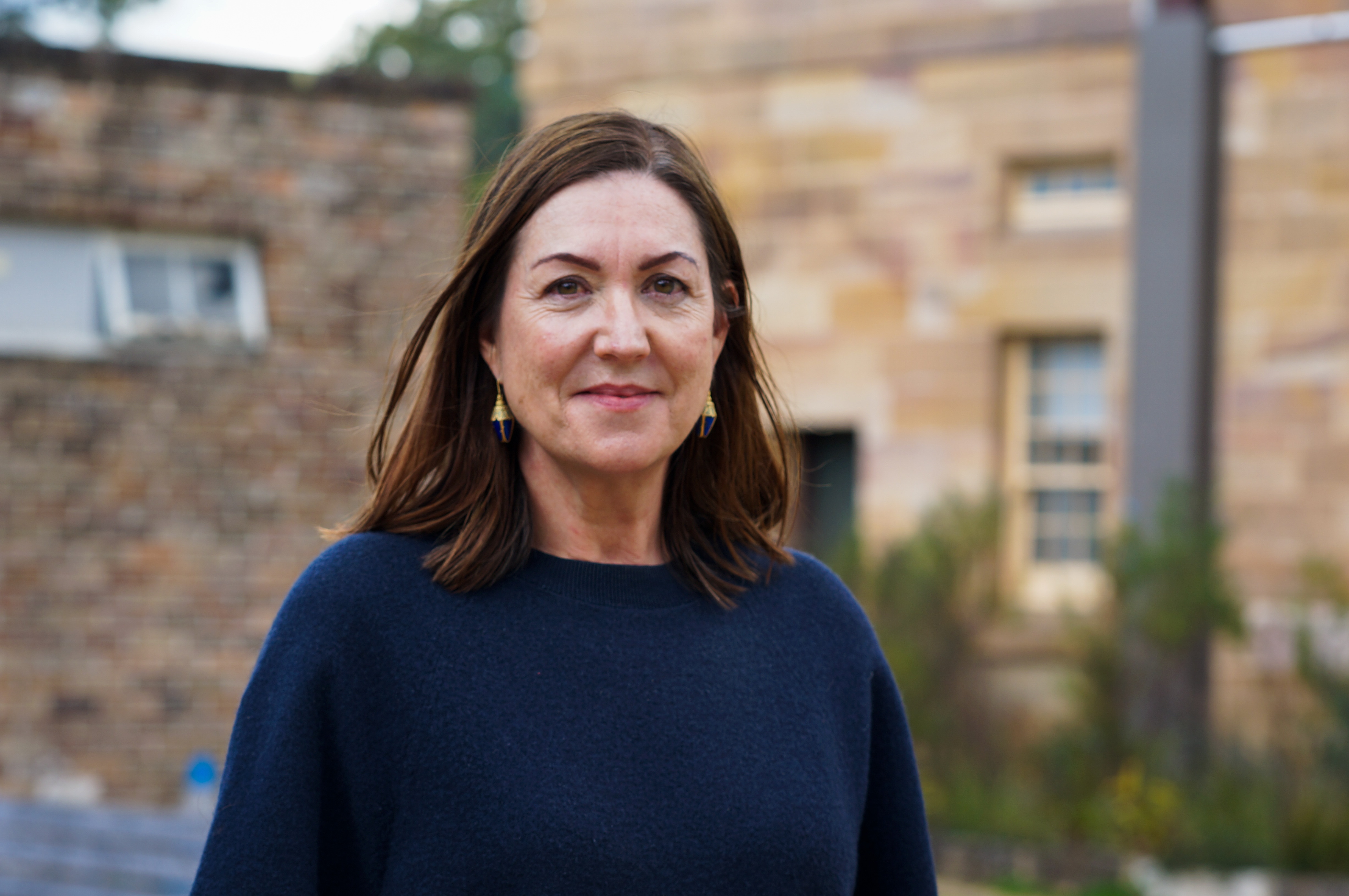 Tania Quax outside building in blue jumper
