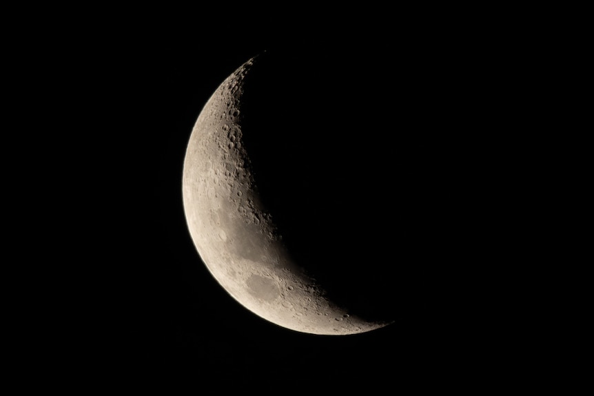 A picture of a waxing moon against the dark night sky