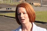 Ms Gillard says the Opposition Leader needs to explain why he has done a "backflip" on the reduction target.