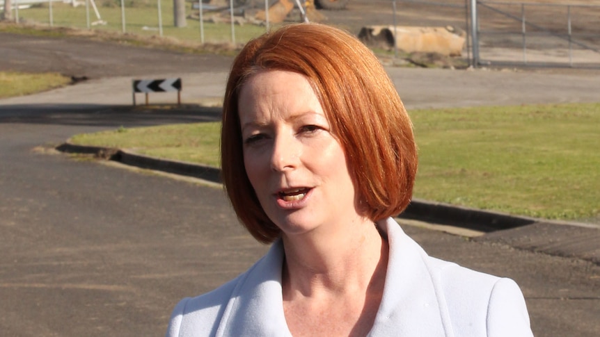 Ms Gillard says the Opposition Leader needs to explain why he has done a "backflip" on the reduction target.