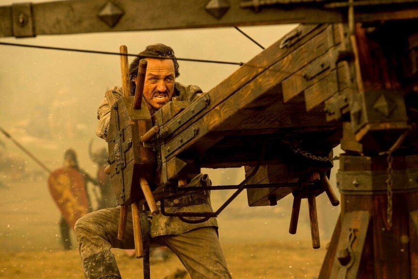 Bronn prepares to fire a ballista in a still image from HBO's Game of Thrones