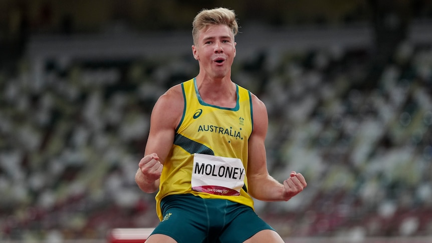 Ashley Moloney pumps his fists while on his knees after completing a decathlon high jump.