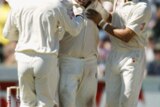 Shane Warne is congratulated by his team-mates.