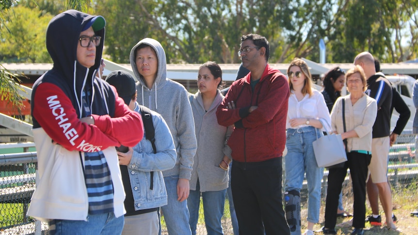 A line of people wearing warm clothing