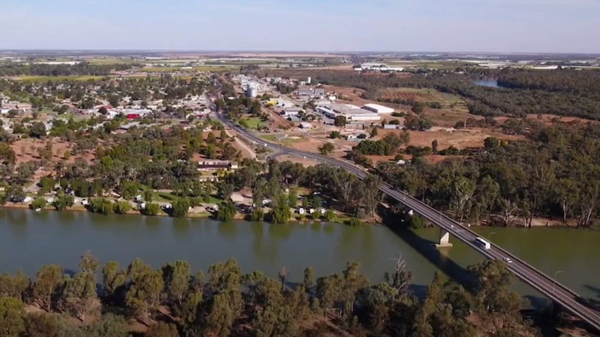 A drone shot that shows a bridge over the Murray River leading into the town of Robinvale.