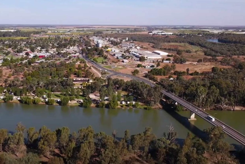 A drone shot that shows a bridge over the Murray River leading into the town of Robinvale.