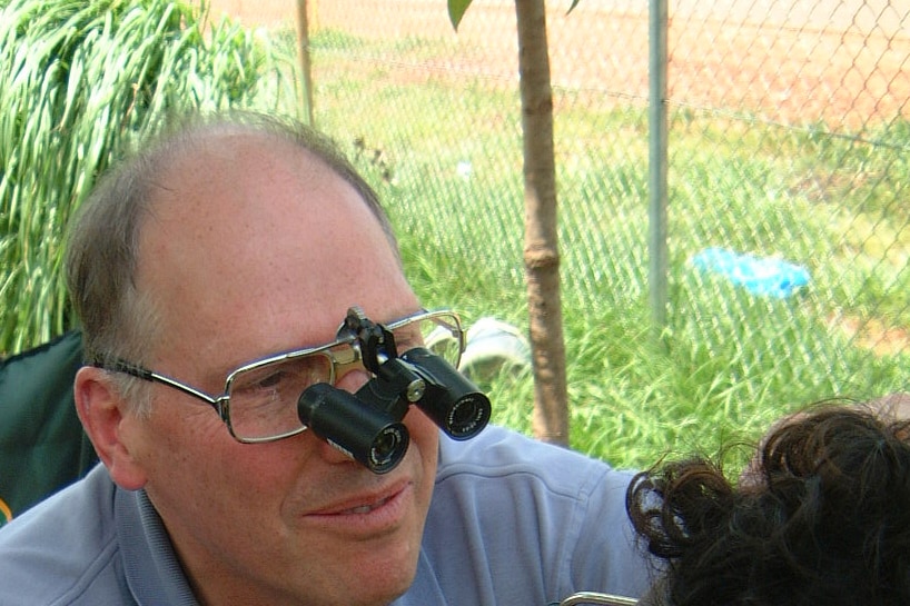 Hugh Taylor examines the eyes of an Aboriginal boy.
