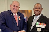 Justin Tkatchenko with PNG's governor general Sir Bob Bofeng Dadae in formal suits. 