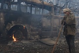 Resident Sean Butler stands in front of his 1958 bus after fighting a fire