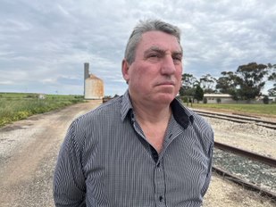 Reid Mather stands along a train line outside of Swan Hill in regional Victoria