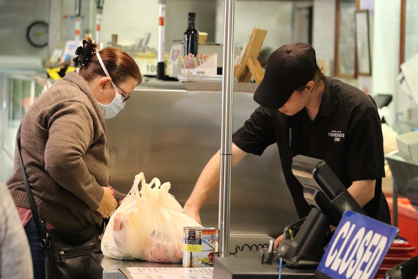 Woman buying seafood in Coffs Harbour