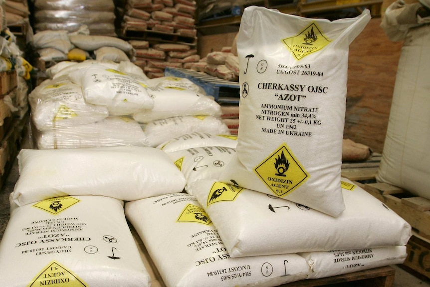Large bags of a hazardous chemical stacked on a crate.