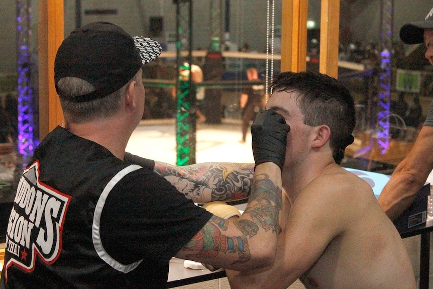 A fighter has his eye patched after a fight